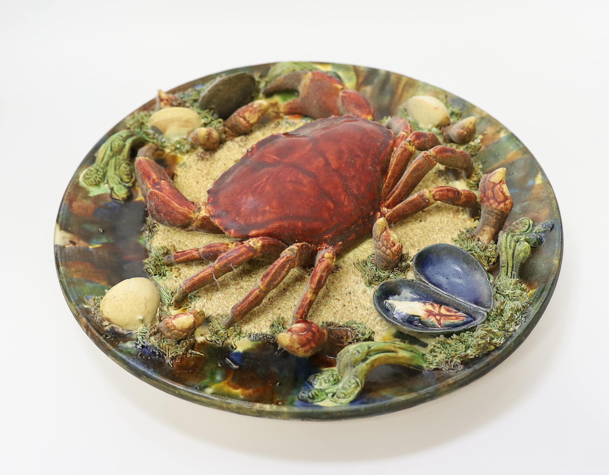 An Alvaro Jose Caldas Da Rainha Palissy ware dish, decorated in relief with a crab and shellfish, stamped to base, 31cm in diameter